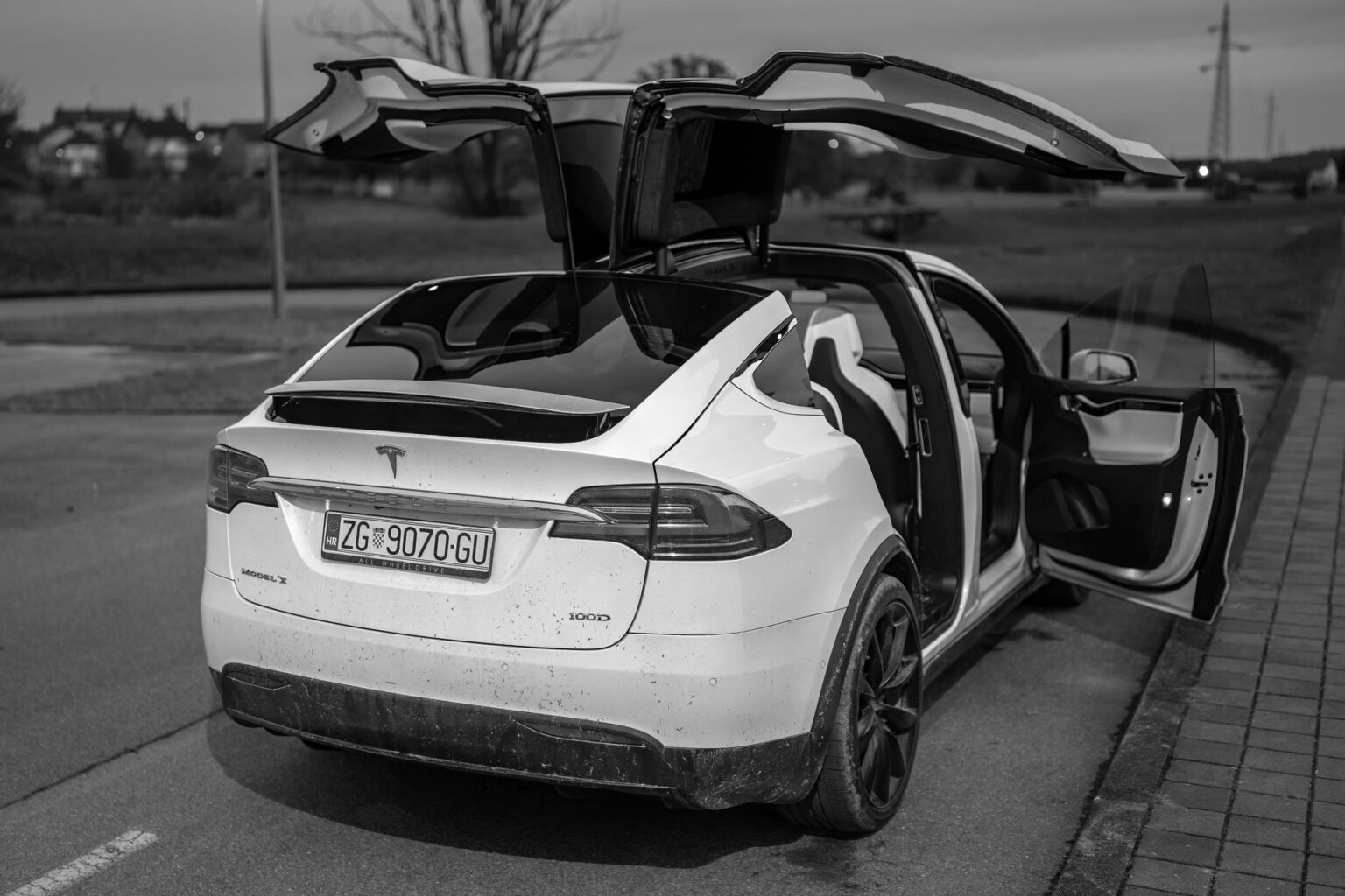 Black and white photo of Tesla Model X with open falcon wing doors in Garešnica, Croatia.