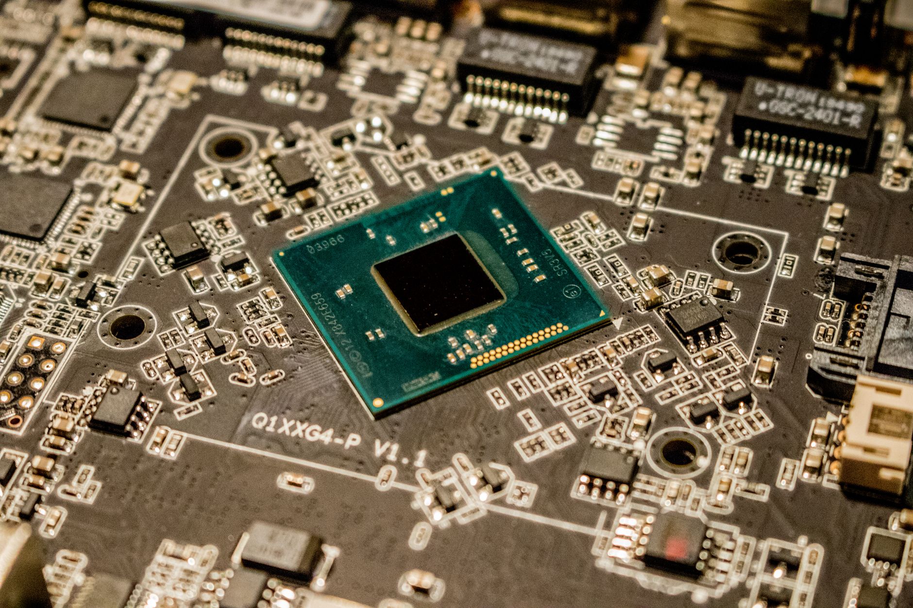 Detailed view of a microchip on a printed circuit board.