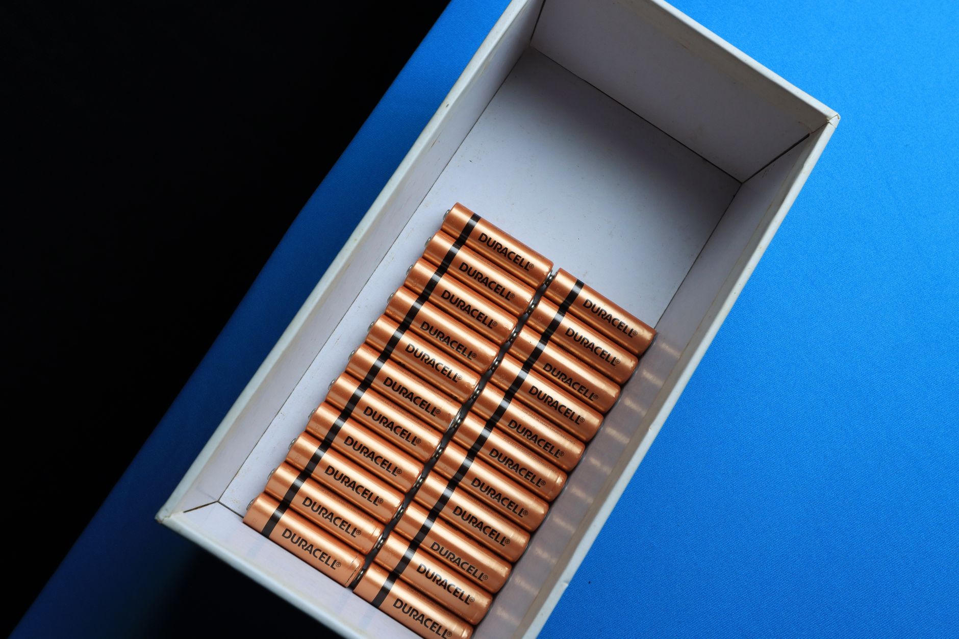 Neatly arranged batteries in a box.