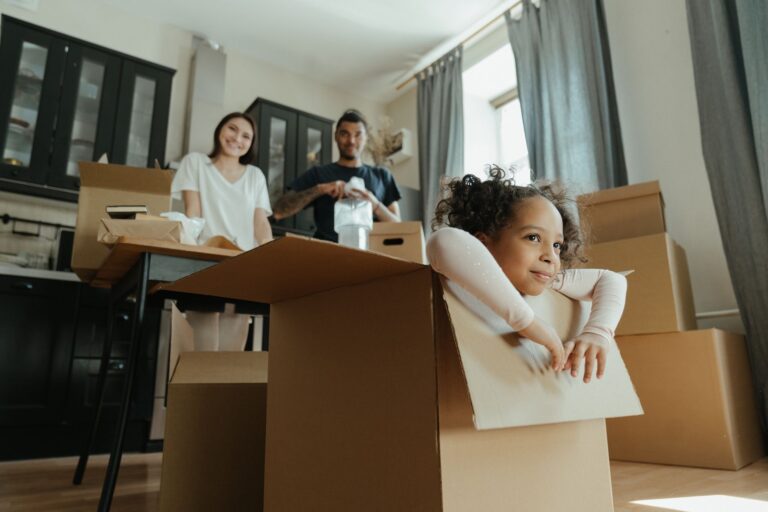 Family unpacking boxes in a new home