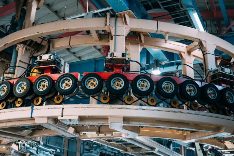 Close-up view of an industrial conveyor system inside a manufacturing facility.