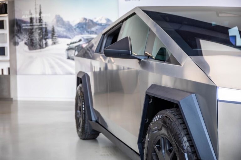 Close-up of a futuristic electric truck showcased indoors, emphasizing modern lines and design.
