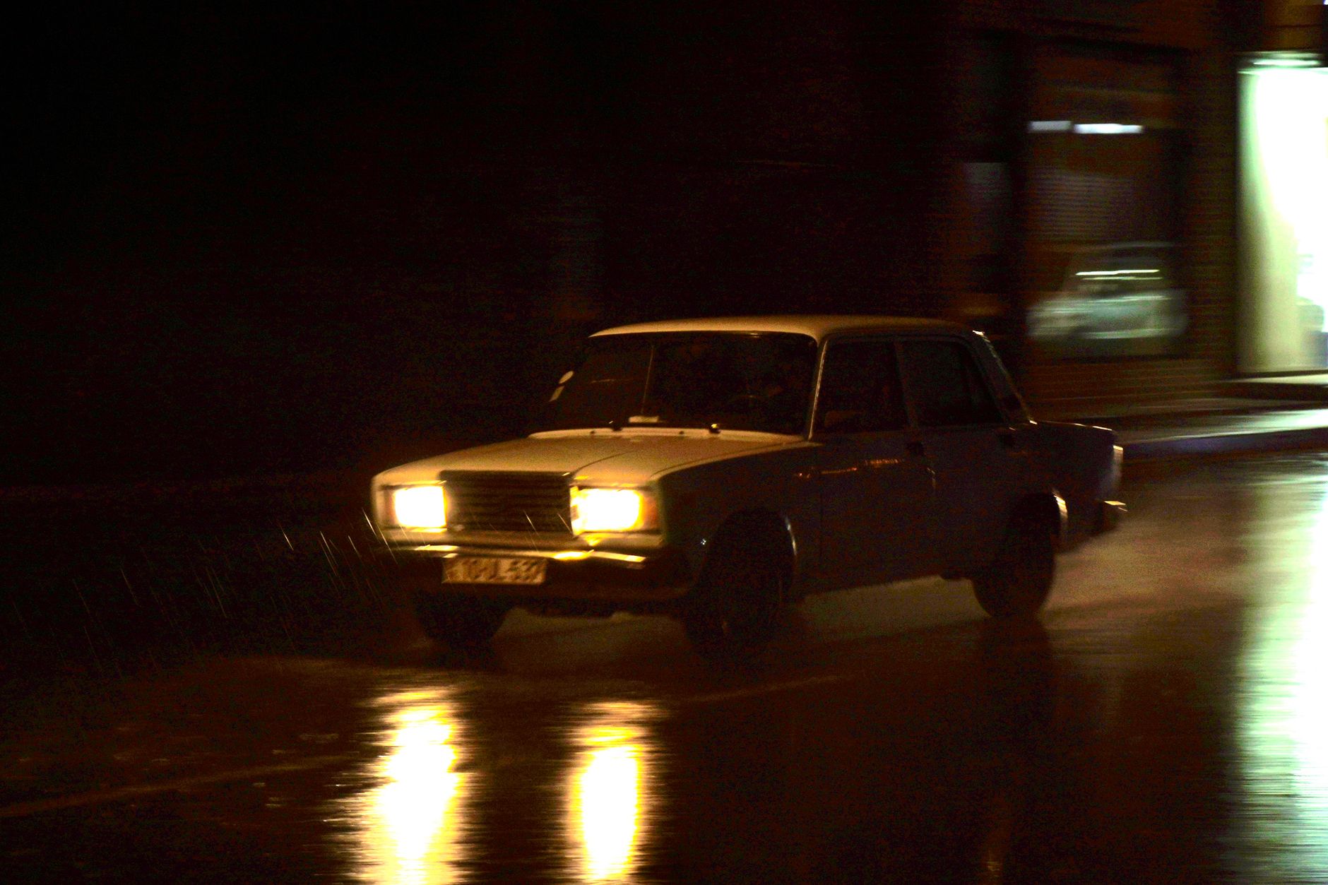 Car headlights on a road at night