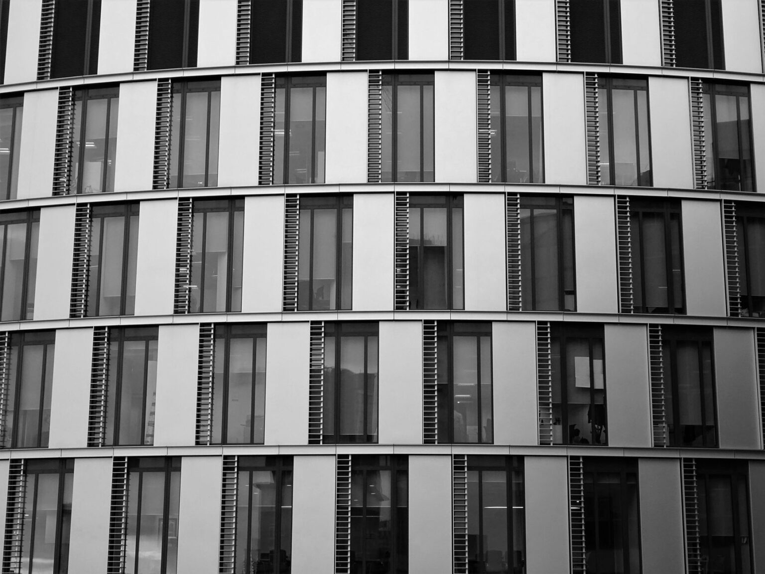 Close-up view of a contemporary office building exterior with glass and steel elements.