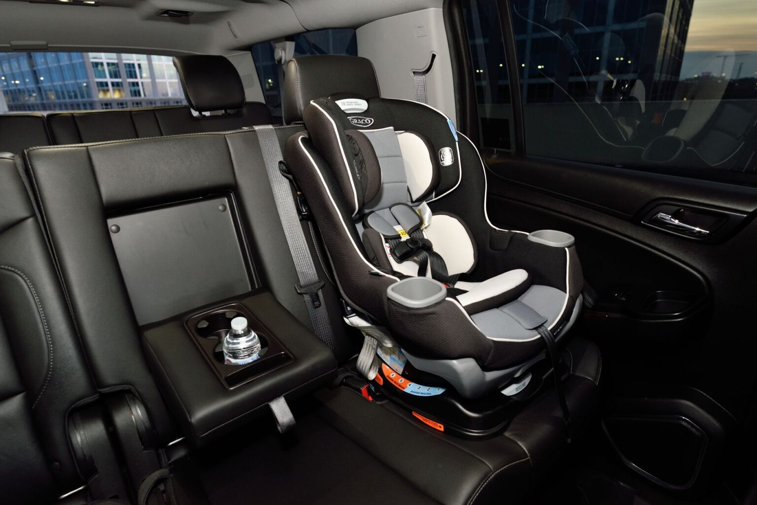 A child safety seat securely installed in the back seat of a modern vehicle.
