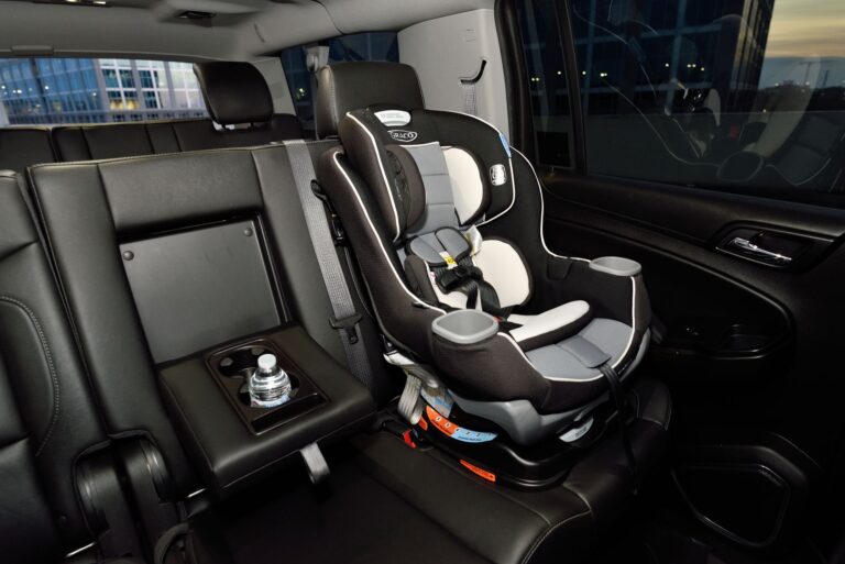 A child safety seat securely installed in the back seat of a modern vehicle.