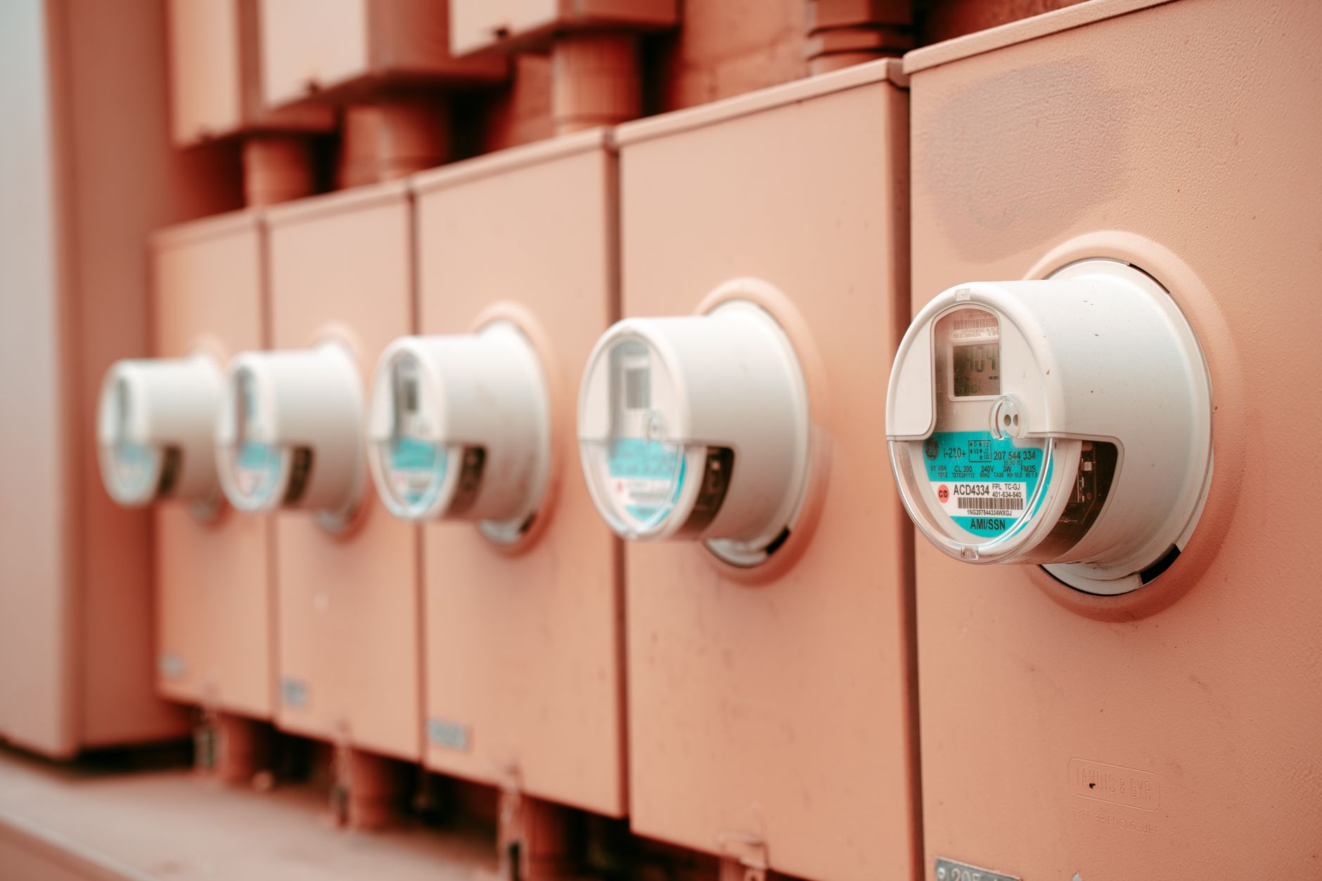 Close-up view of a row of industrial electricity meters for power monitoring.