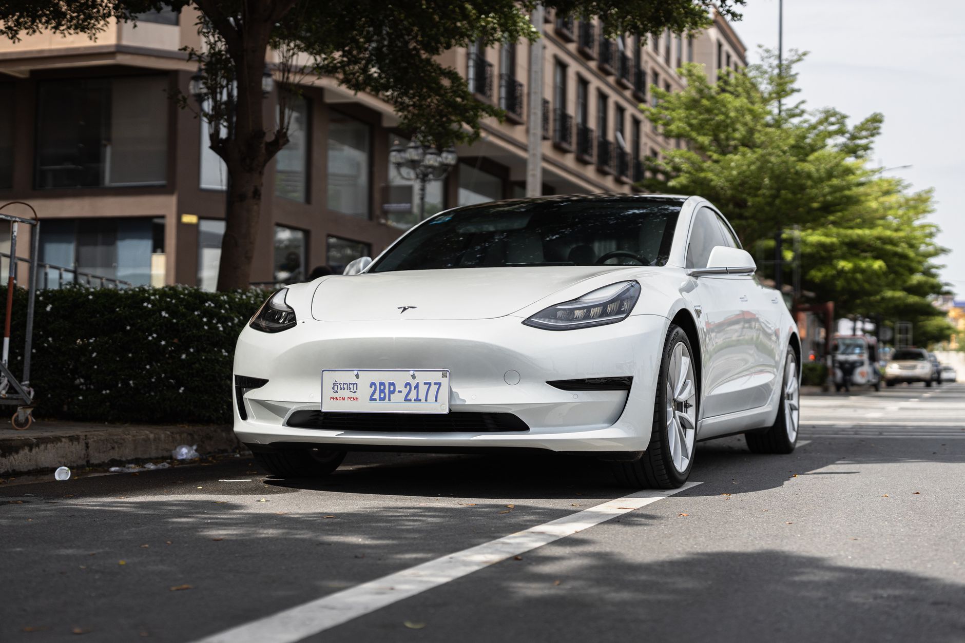 White Tesla Model 3 parked on a city street