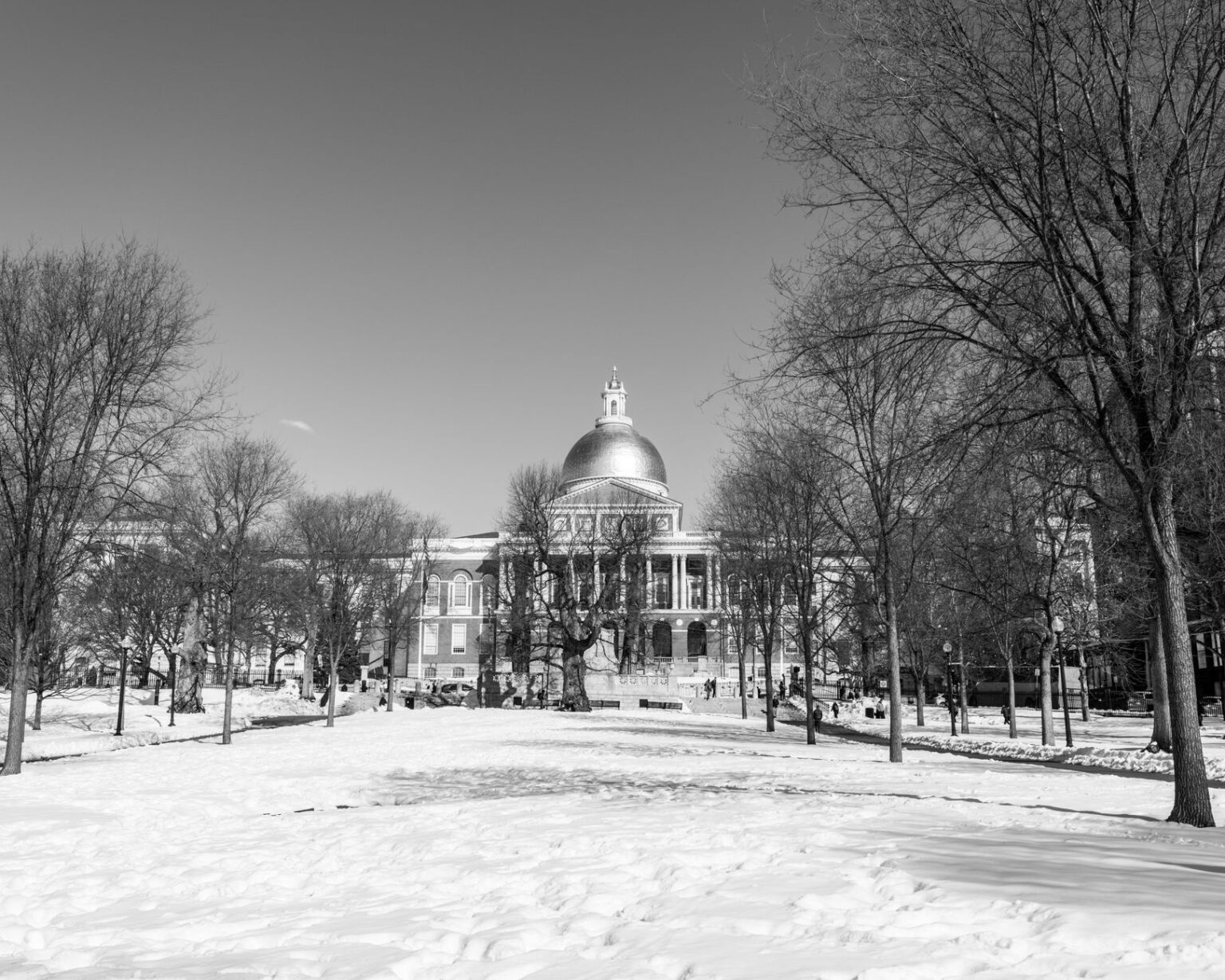 Black and white photo of the Massachusetts State House during winter in Boston.
