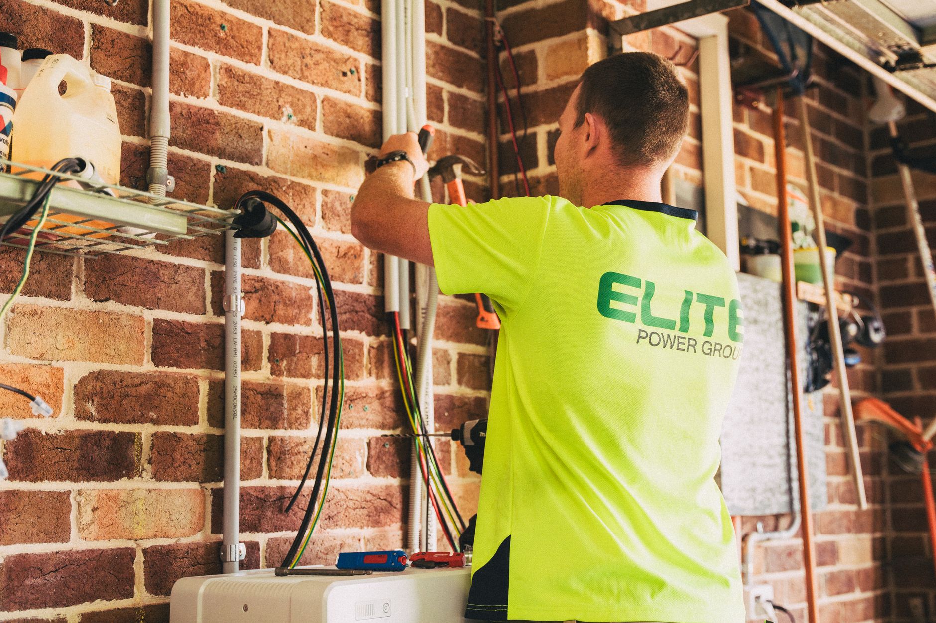 Electrician performing solar battery installation for home energy storage