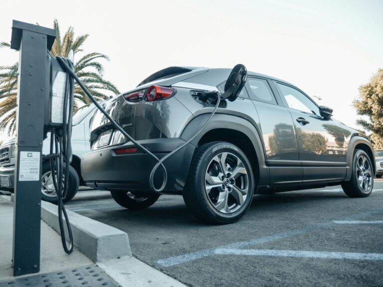 Modern electric vehicle charging at an outdoor station in daylight