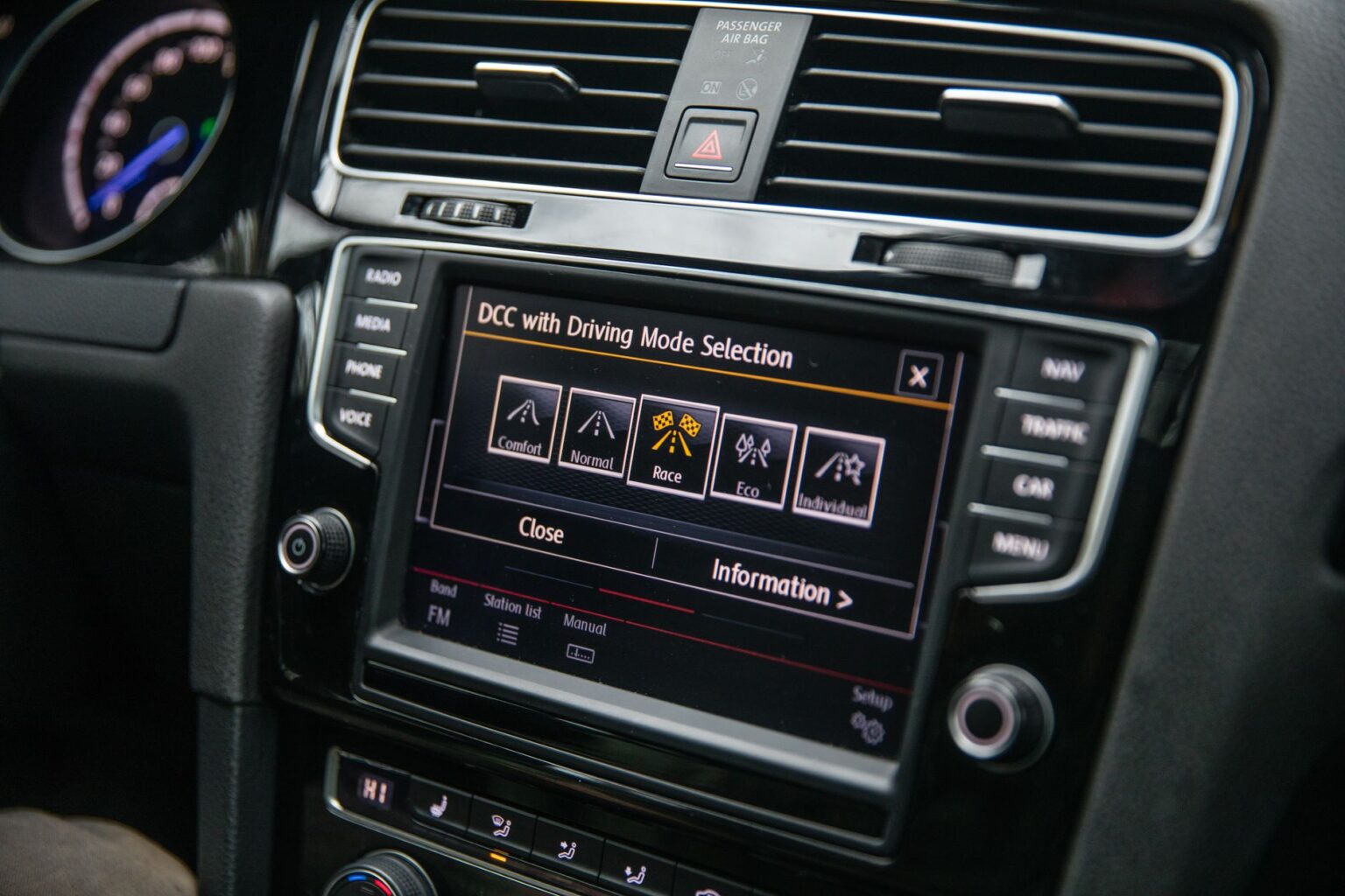 Close-up view of a car's touchscreen display showing driving mode options, enhancing vehicle control.