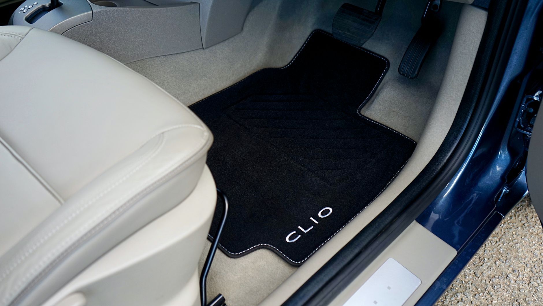 Close-up of car interior showcasing a customized floor mat.