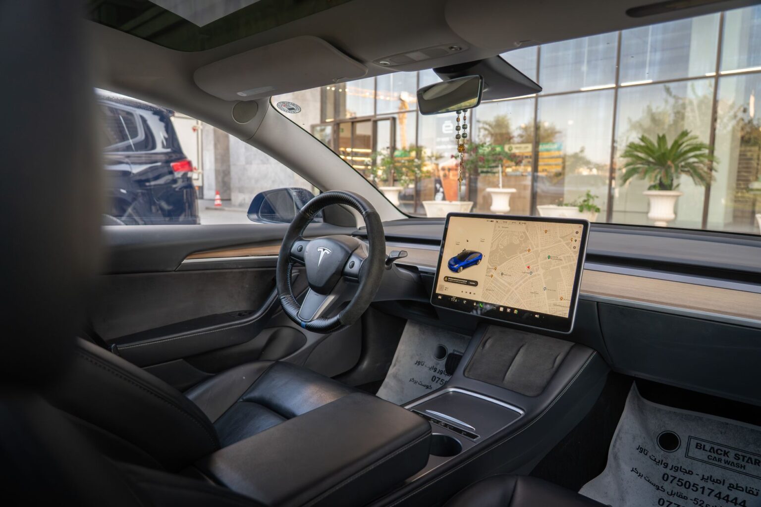 Tesla Model 3 interior showcasing navigation screen and sleek design, ideal for modern automotive themes.