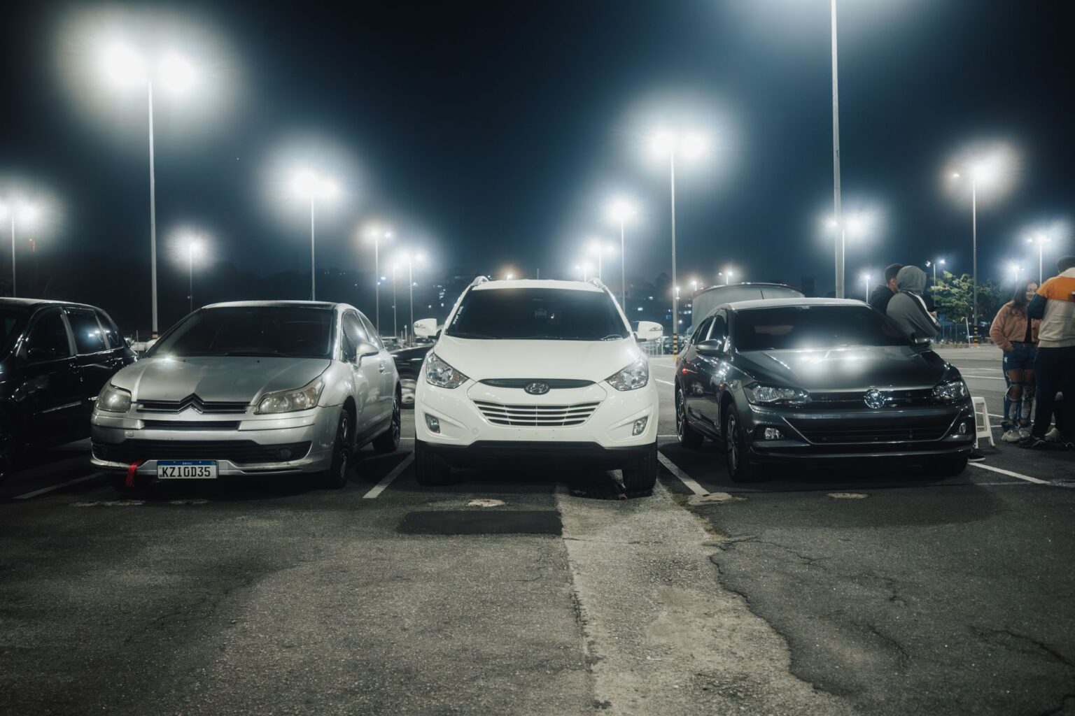 Electric cars parked in a lot at night