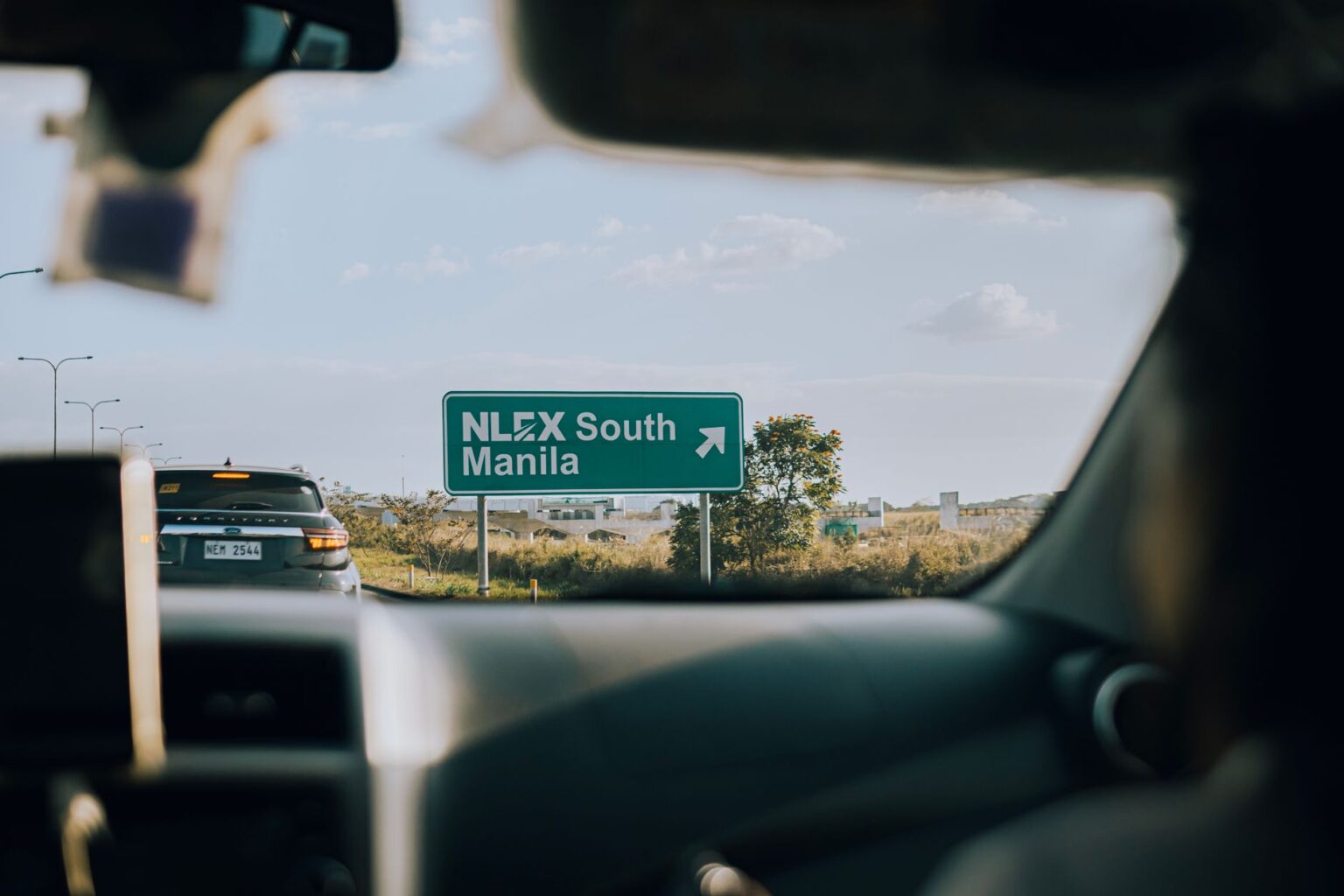 View from a car driving toward a highway toll road sign